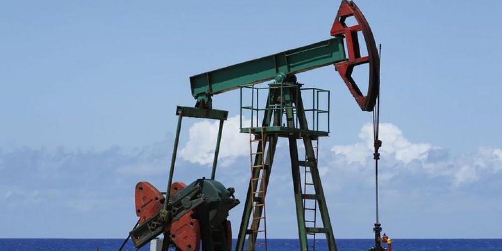 Oil prices down as strong dollar overshadows OPEC cut optimism