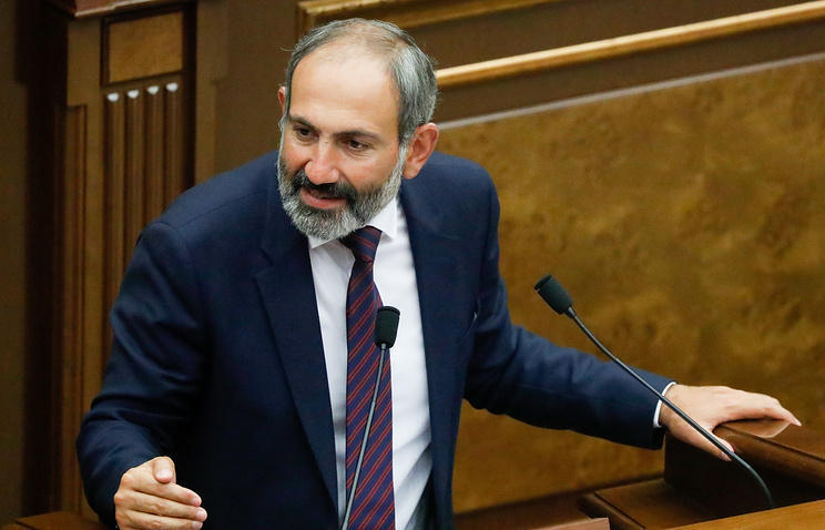 Pashinyan "learning" the art of sitting on two chairs