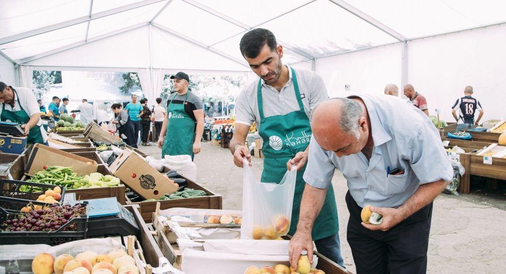 Farmers offer products at trade fair