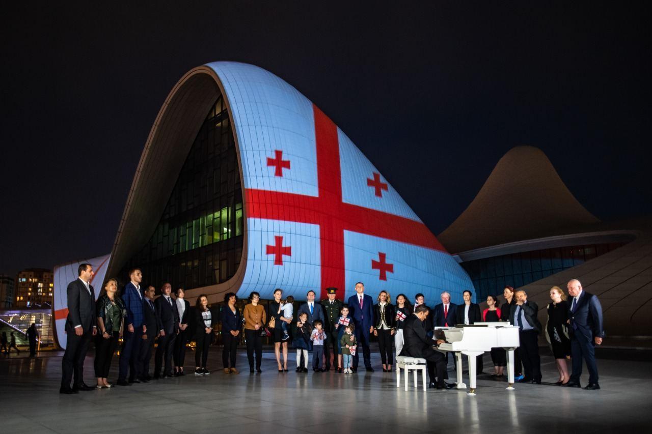 Building of Heydar Aliyev Center illuminated by Georgian flag