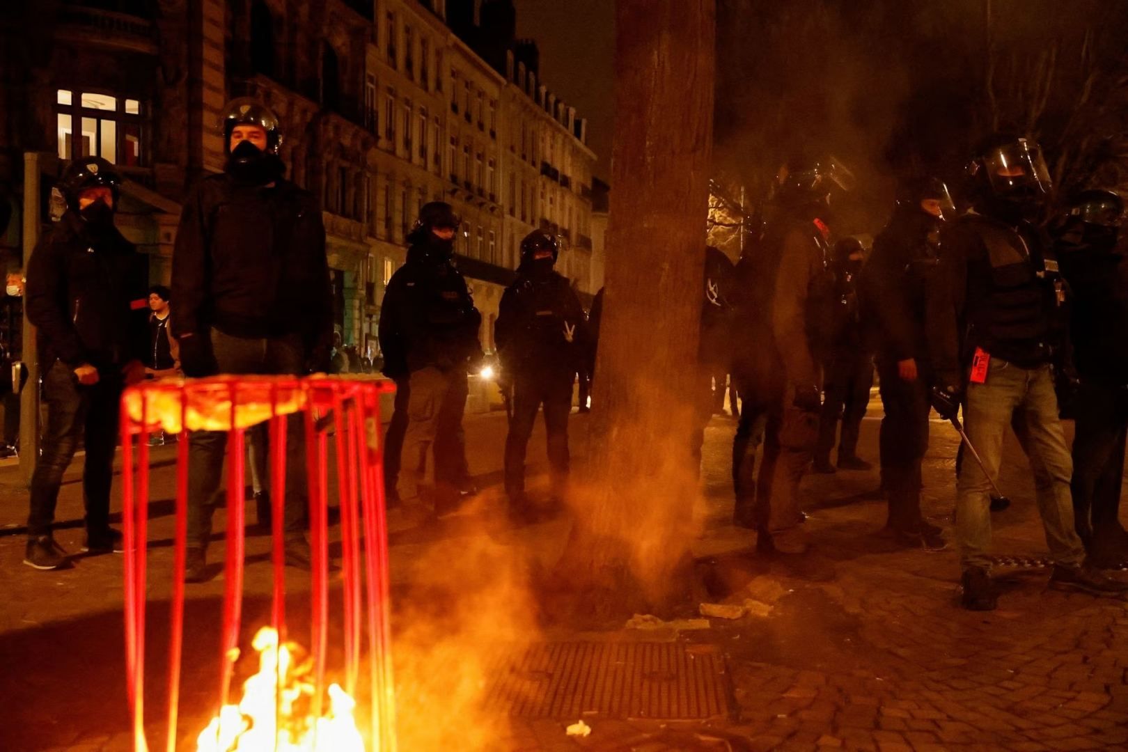 Protesters set rubbish on fire as French govt barely survives no-confidence vote