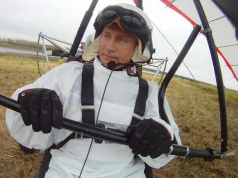 Putin suits up, flies with cranes