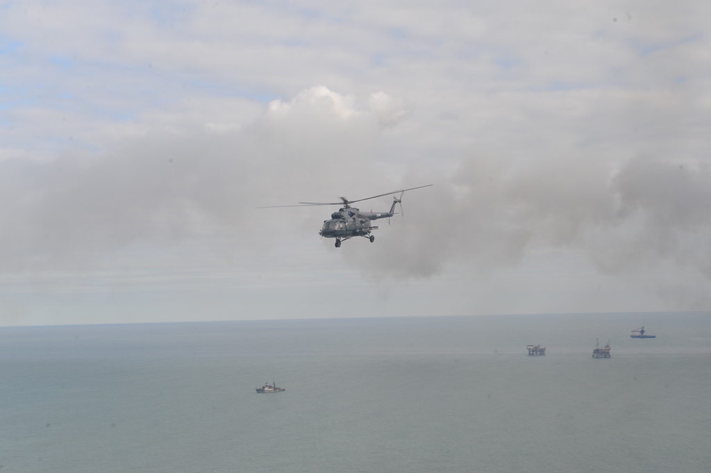 Helicopters, vessels search missing oilmen