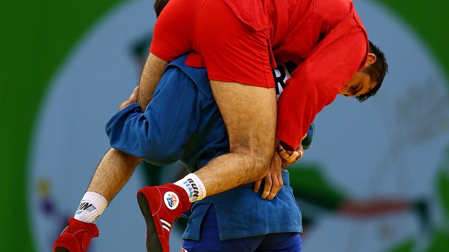 Victorious Sambo fighter carries injured opponent off